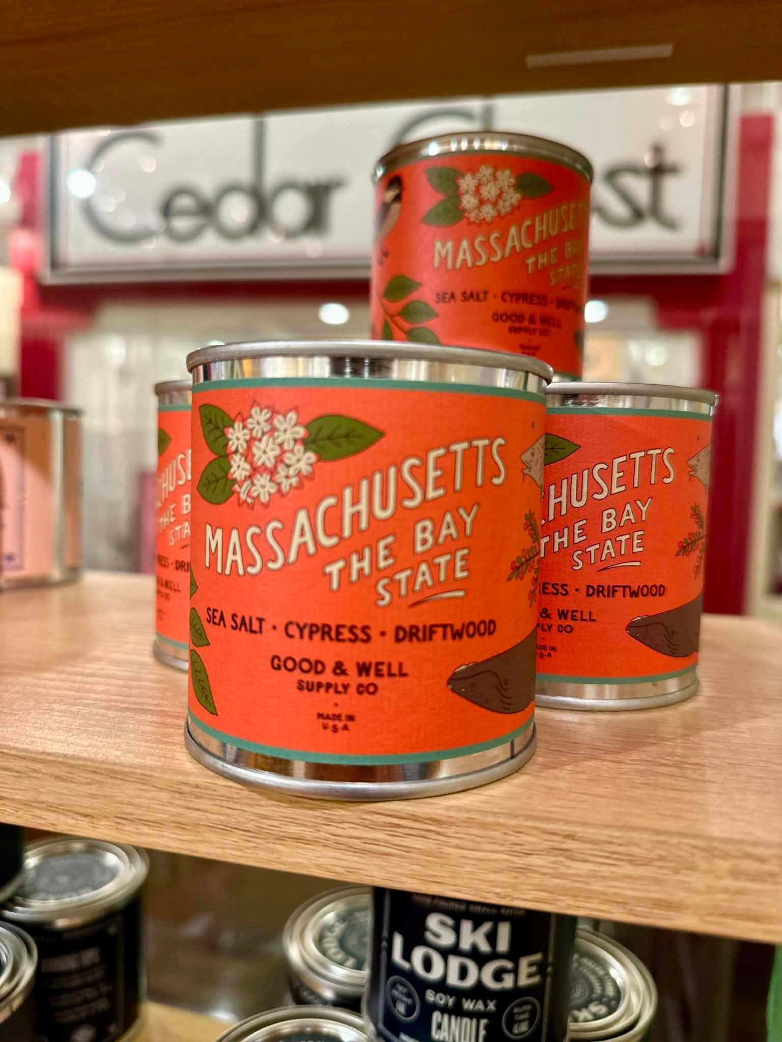Massachusetts-inspired candles on a shop shelf